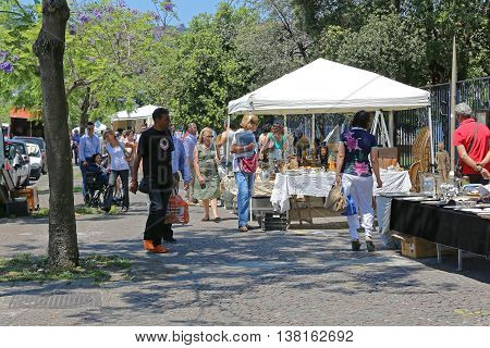 NAPLES ITALY - JUNE 22: Sunday Antique Market in Naples on JUNE 22 2014. People Browsing For Antiques at Seafront Promenade Lungomare in Napoli Italy.