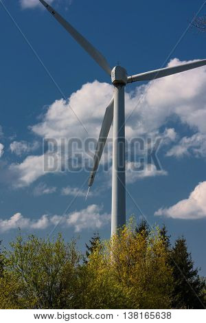 Windmill surrounded by the natural nature on a sunny day.