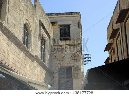old house with decorative elements on a narrow street