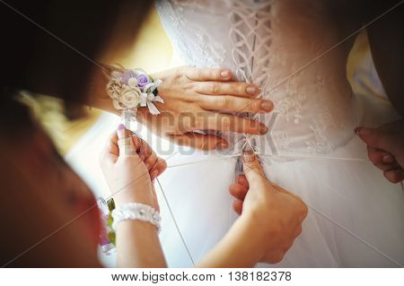 Bridesmaid wearing dress of bride at wedding