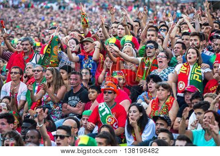 PORTO, PORTUGAL - JUL 10, 2016: Portuguese fans during translation of the football match Portugal - France final of the European championship 2016, in Liberdade Square at city center of Porto. 