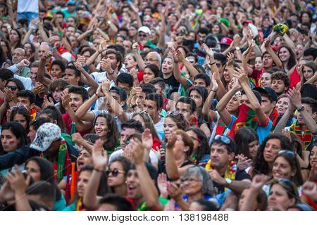 PORTO, PORTUGAL - JUL 10, 2016: Portuguese fans during translation of the football match Portugal - France final of the European championship 2016, in Liberdade Square at city center of Porto. 