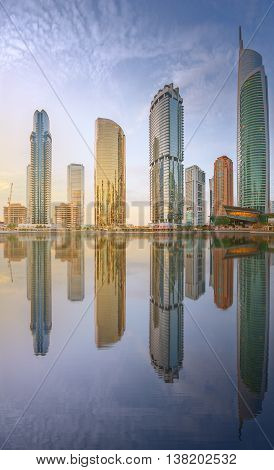 Panoramic view of Business bay and Lake Tower, reflection in a river, Dubai UAE.