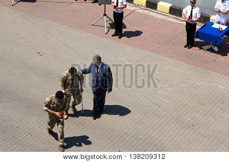 Odesa, Ukraine - July 03, 2016: President Petro Poroshenko helps wounded soldier after awarding. Navy day celebration in Odesa