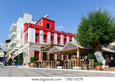 Street of Sitia town with beautiful hauses and tavernas on Crete island, Greece