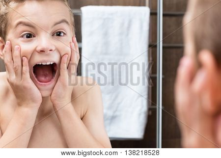 Closeup portrait of a teen boy crying in the bathroom