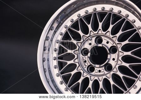 Aluminum metal wheel rim texture. Car alloy wheel, isolated on black background. Classic drive.