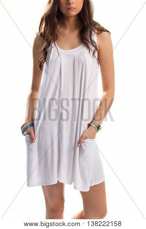 Girl in white sarafan. Watch and set of bracelets. Simple garment with colorful accessories. Apparel for hot weather.