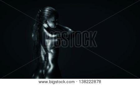 Young fit athletic woman in silver body paint, standing back to camera. Lot of copy space