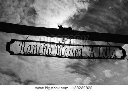 Rancho Blessed A Lotta wooden driveway signpost