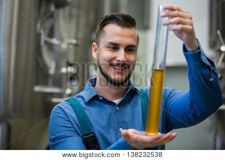 Happy brewer hydrometer cylinder at brewery