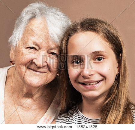 Portrait smiling grandmother and granddaughter at home