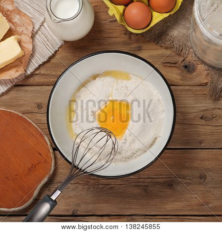 Ingredients for cooking bakery products on wooden table in bakery top view