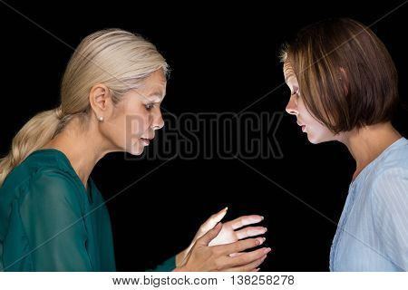Hypnotist hypnotizing woman against black background