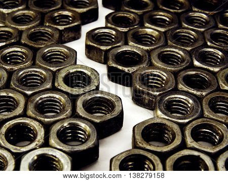 background or pattern of steel nuts with metric thread