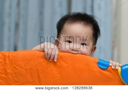 Asian Baby In Playpen