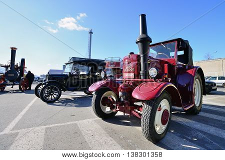 KAUNAS, LITHUANIA - MAR 23: Vintage tractor in antique car show in a traditional flea market in second biggest Lithuanian city - Kaunas, on March 23, 2013 in Kaunas, Lithuania