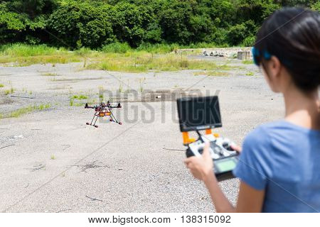 Woman control with drone at outdoor