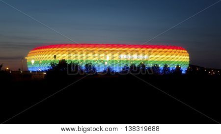 MUNICH, GERMANY - JULY 9, 2016: Long exposure of a highway at night with Allianz Arena, colored in rainbow colors for CSD weekend, Munich, Bavaria, Germany