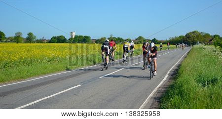 Grafham, Cambridgeshire, England - May 22, 2016:  Triathletes on road cycling stage of triathlon riding in both directions.