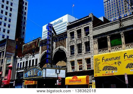 Newark New Jersey - July 5 2009: Early 20th century buildings house stores and the old Paramount Newark movie theatre on Market Street