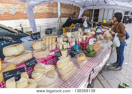GRENOBLE FRANCE - JUNE 19 2016: French cheese sales stand at the Sunday Market in Grenoble city France