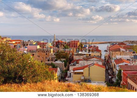 The medieval city with lighthouse in old harbour, aerial view from Schiavo Bastion in the evening, Crete, Greece