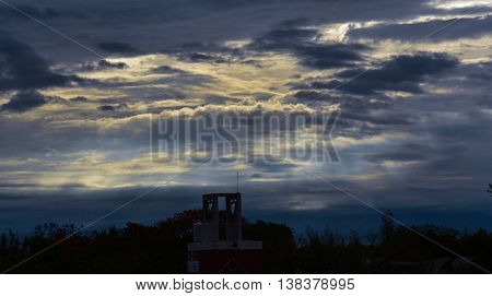 Sun rays behind clouds after a storm.