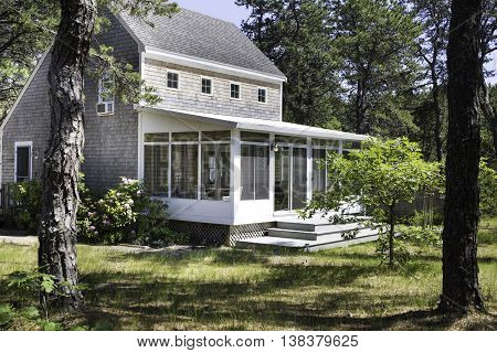 Salt box house in the forest in Wellfleet, MA on Cape Cod.