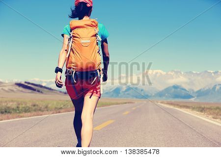 young woman hiker hiking at beautiful mountain trail