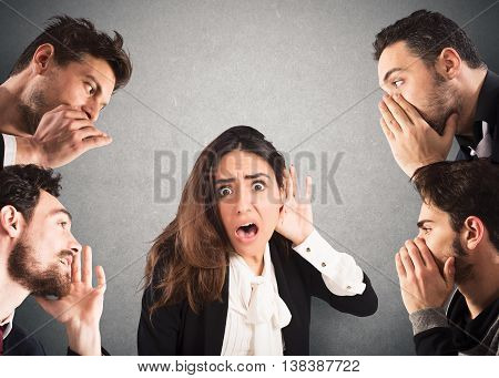 Girl with shocked expression listening to many people