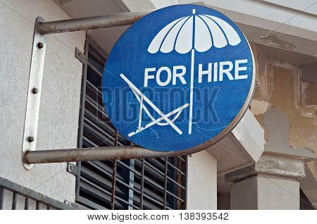 Sign advertising beach chairs and umbrellas for hire