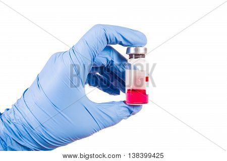 Medical theme: doctor's hand in a white glove holding a vial of clear liquid for injection isolated on white background vaccine veterinary medicine