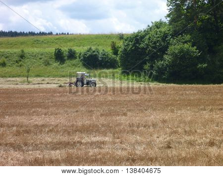Tractor Harwesting Crops On A Field