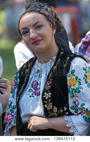 ROMANIA TIMISOARA - JULY 10 2016:Young woman from Romania in traditional costume present at the international folk festival "International Festival of hearts" organized by the City Hall Timisoara.