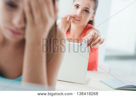 Students Passing A Cheat Sheet