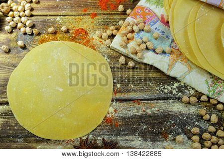 Colorful Indian food - papadum chickpea gram flour and spices on textured wooden table top