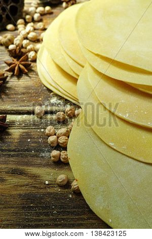 Colorful Indian food - papadum chickpea gram flour and spices on textured wooden table top