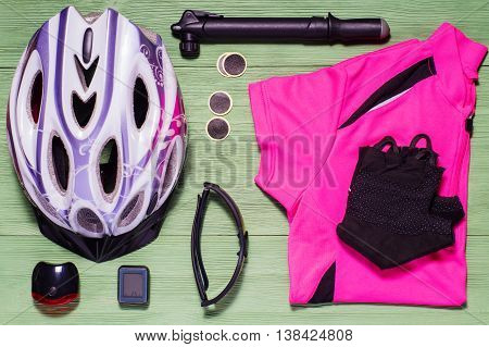 Items replacements and tools for a safe cycling: Helmet shirt gloves glasses pump patches, flat lay. Tools and accessories set for cycling flat lay. Sport equipment sports uniform, top view.