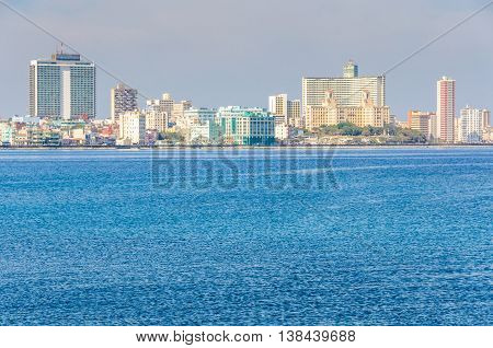 HAVANA, CUBA - MARCH 17, 2016: The skyline of the Vedado neighborhood with its skyscraper hotels on the shore in Havana the capital of Cuba