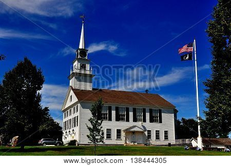 Rindge New Hampshire - July 11 2013: The white wooden colonial 1796 Second Rindge Meeting House and Town Hall overlooking the Village Green 