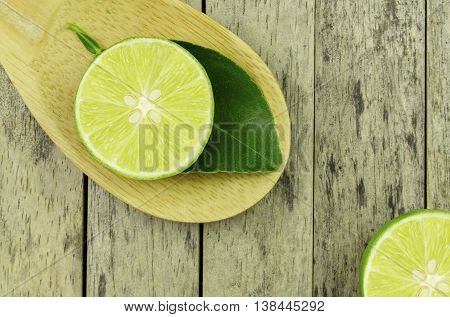 lime slice and leaf on wood padle