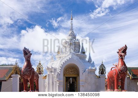 Lamphun Thailand - December 10 2014: Ancient Arched Entrance And The Pair Sculptured Of Lions Animals In Fiction Inside Wat Phra That Hariphunchai At Blue Sky Background.
