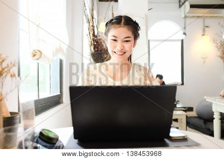 Freelance E Business Asian Women Using Laptop Computer In Coffee Shop