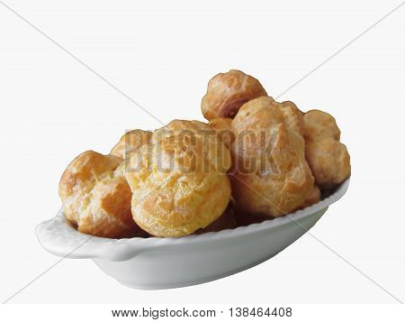 Delicious beignets composed of a shell of choux pastry isolated on white background