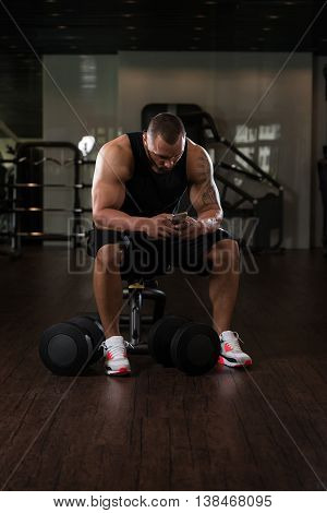 Healthy Man Using Smartphone While Resting