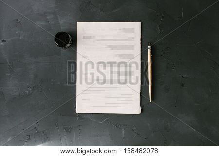 notesheet on the black stone background. above view