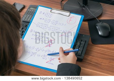 Teacher Is Correcting And Grades Math Exam In School And Gives F