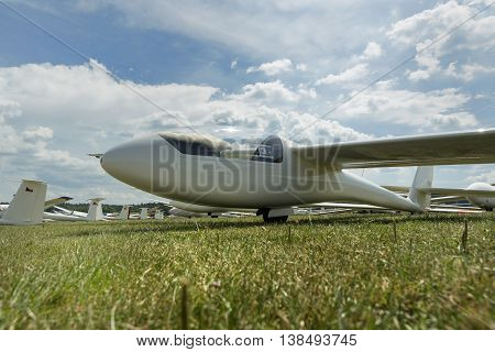 gliders at green airfield with blue sky