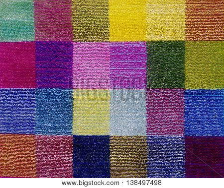 Multicolored carpet background divided in small rectangules